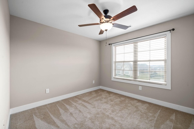 unfurnished room featuring light colored carpet and ceiling fan