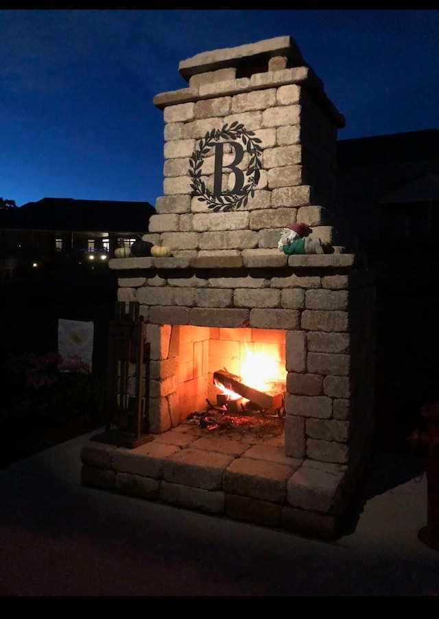 exterior details featuring an outdoor stone fireplace