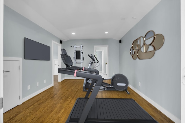 workout area with wood-type flooring and vaulted ceiling