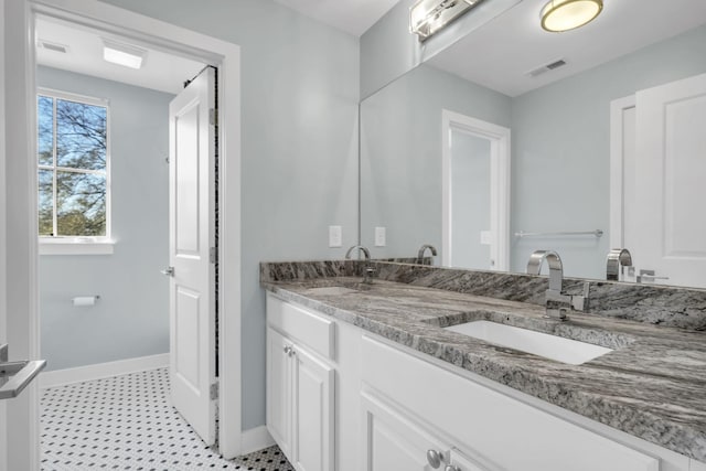 bathroom with vanity and tile patterned flooring