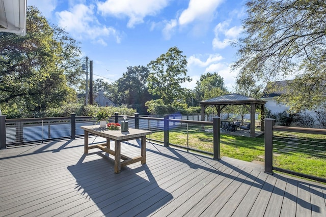 wooden terrace featuring a gazebo and a lawn