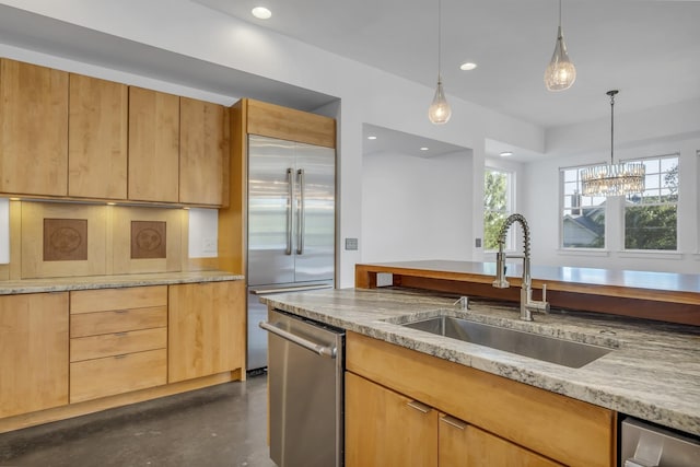 kitchen with a wealth of natural light, pendant lighting, sink, light stone counters, and stainless steel appliances