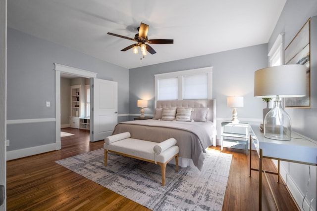 bedroom with dark hardwood / wood-style flooring and ceiling fan