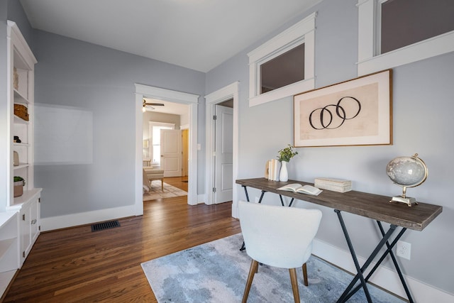 office space with ceiling fan and dark hardwood / wood-style flooring