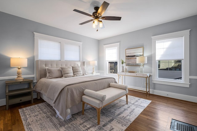 bedroom with ceiling fan and dark hardwood / wood-style flooring