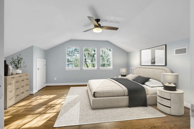 bedroom featuring wood-type flooring, lofted ceiling, and ceiling fan