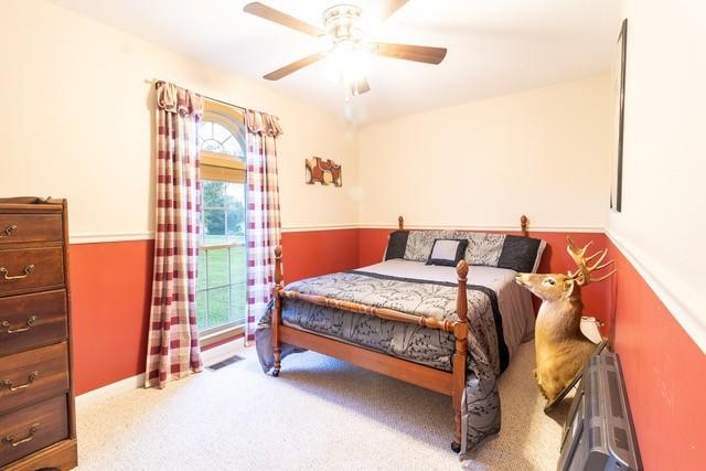 carpeted bedroom featuring ceiling fan