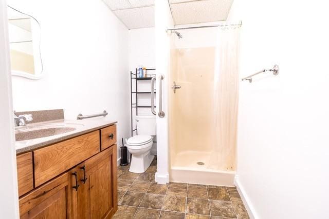 bathroom featuring vanity, toilet, and walk in shower