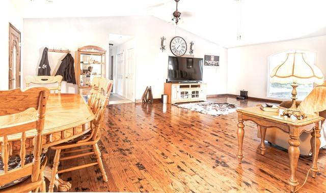 dining space featuring hardwood / wood-style floors and vaulted ceiling