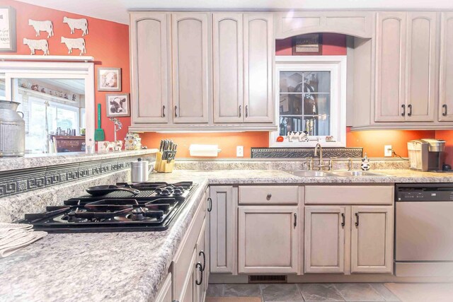 kitchen featuring stainless steel dishwasher, sink, and gas stovetop