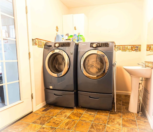 laundry area featuring cabinets and washer and clothes dryer