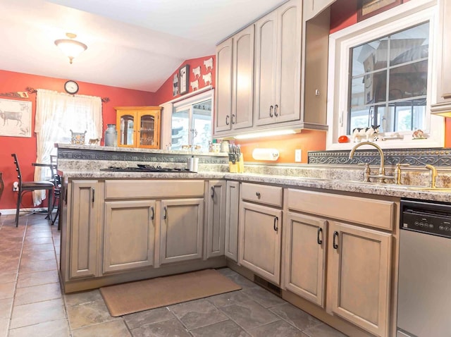 kitchen featuring vaulted ceiling, sink, stainless steel dishwasher, kitchen peninsula, and black gas stovetop