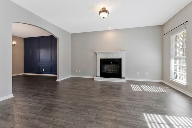 unfurnished living room with dark hardwood / wood-style flooring