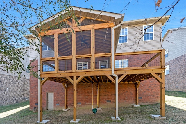 back of house featuring a sunroom and a deck