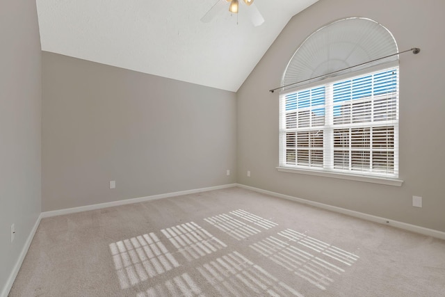 unfurnished room featuring vaulted ceiling, light colored carpet, and ceiling fan