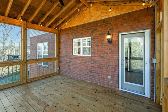 exterior space with plenty of natural light and lofted ceiling with beams