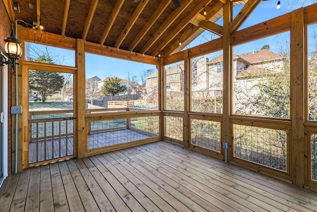 unfurnished sunroom featuring a healthy amount of sunlight and lofted ceiling