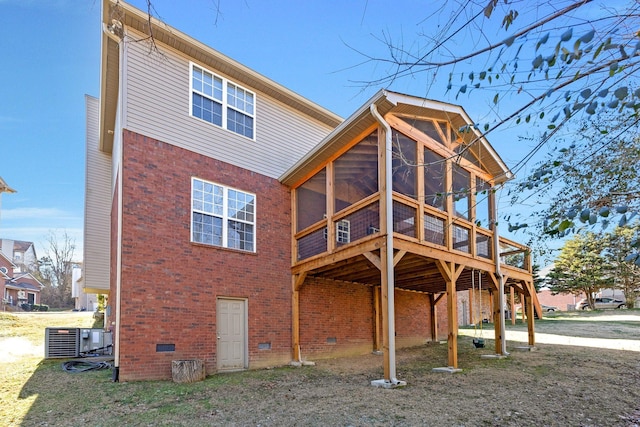 back of property with central AC, a wooden deck, and a sunroom