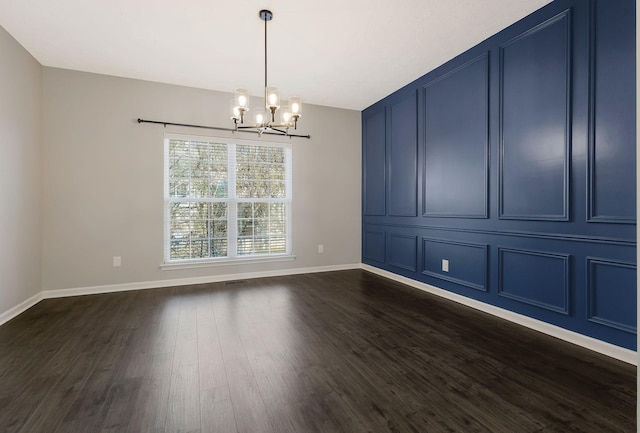 unfurnished dining area featuring an inviting chandelier and dark hardwood / wood-style flooring