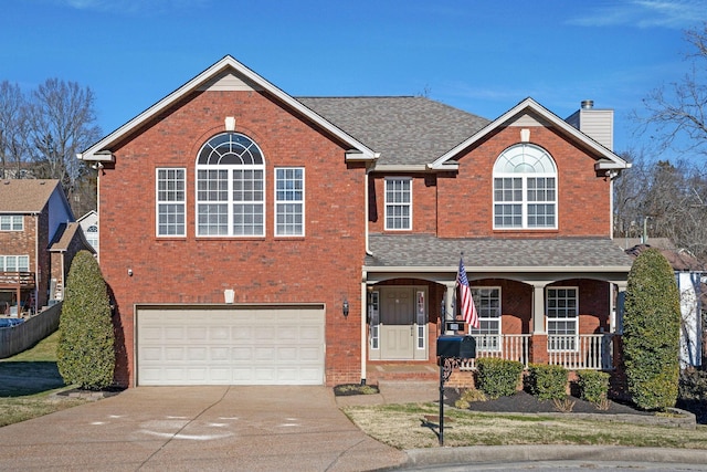 view of front facade with a garage and a porch