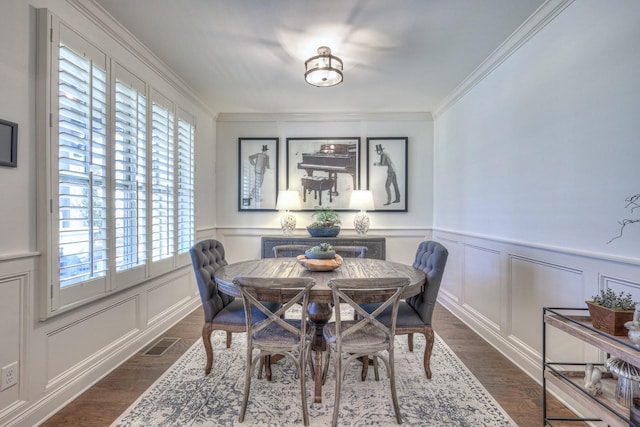 dining area featuring crown molding and dark wood-type flooring