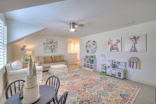 carpeted living room with ceiling fan