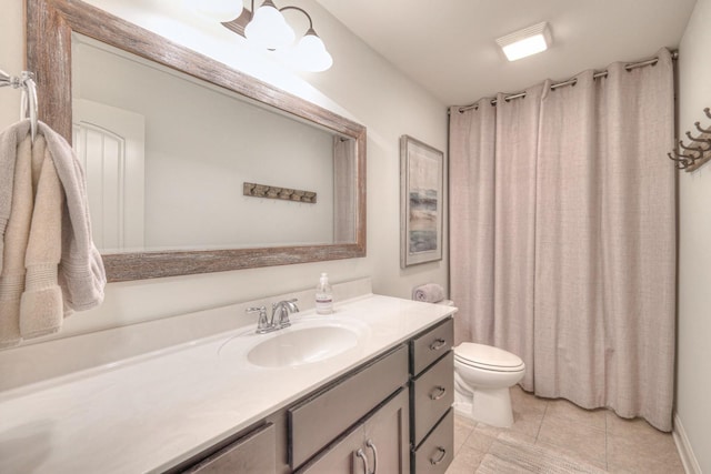 bathroom featuring tile patterned flooring, vanity, and toilet