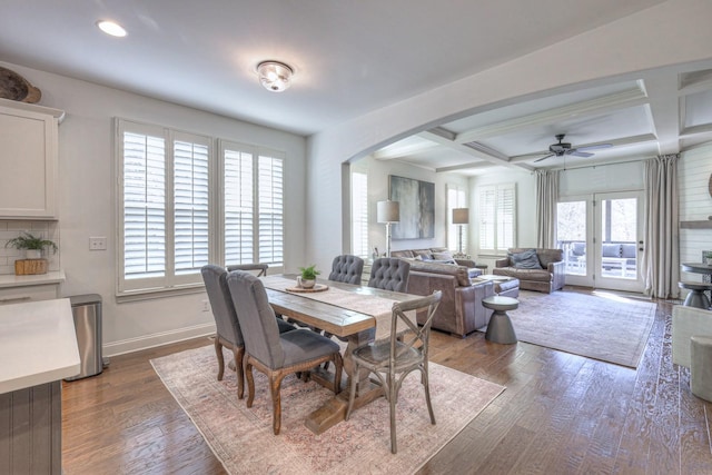 dining room featuring ceiling fan, coffered ceiling, dark hardwood / wood-style flooring, and beam ceiling