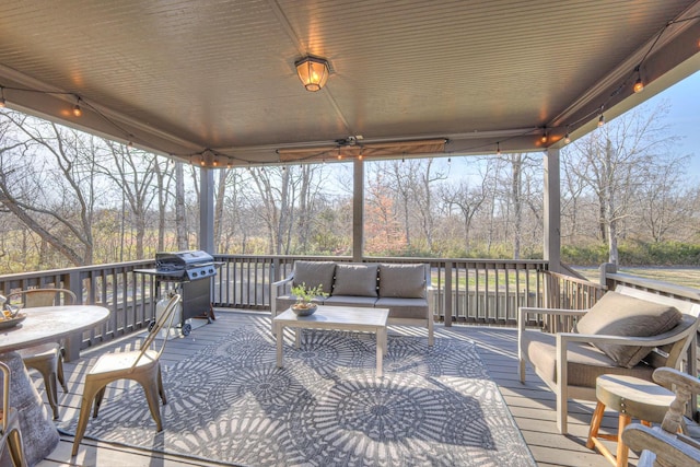 wooden terrace featuring a grill and an outdoor hangout area