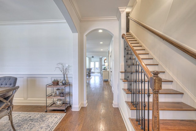 interior space featuring ceiling fan, ornamental molding, and dark hardwood / wood-style floors