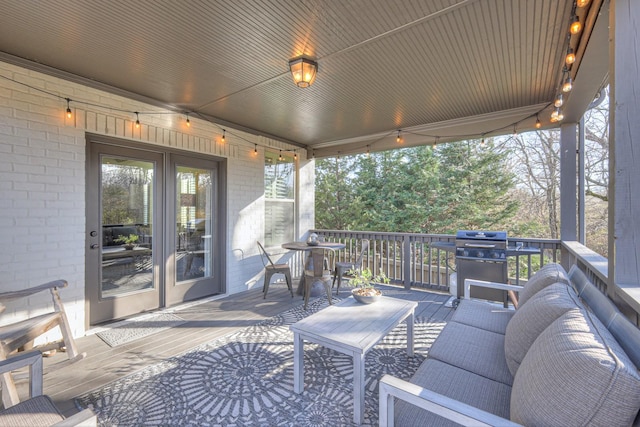 deck with a grill and an outdoor hangout area