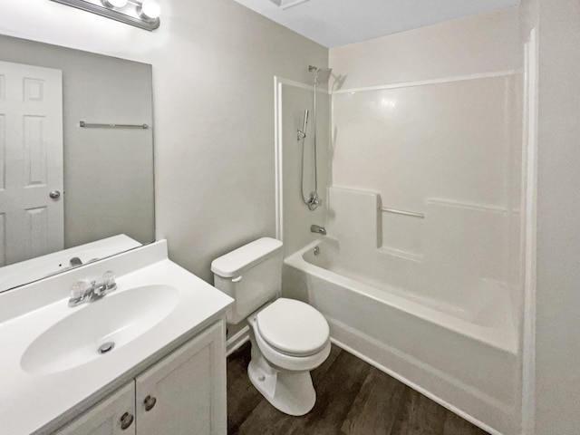 full bathroom featuring hardwood / wood-style flooring, vanity, bathtub / shower combination, and toilet