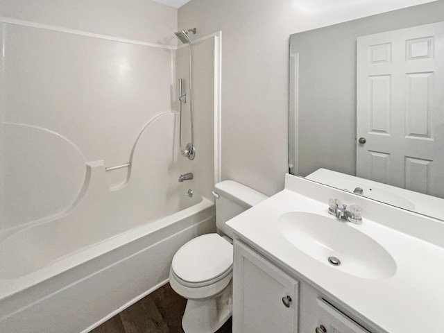 full bathroom with hardwood / wood-style flooring, vanity, toilet, and  shower combination