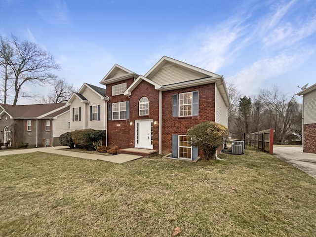 view of front of home with central AC and a front lawn