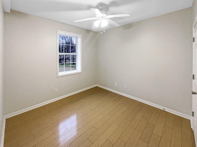 spare room featuring hardwood / wood-style flooring and ceiling fan