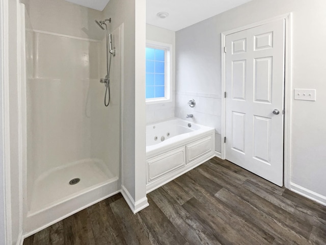 bathroom with plus walk in shower and hardwood / wood-style floors