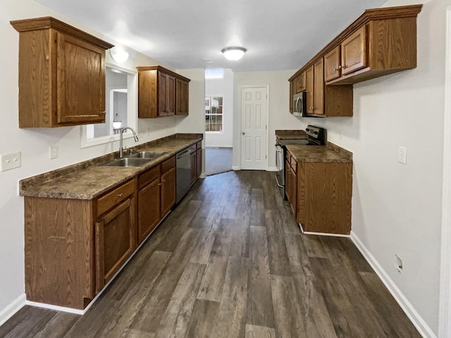 kitchen featuring appliances with stainless steel finishes, dark hardwood / wood-style floors, and sink