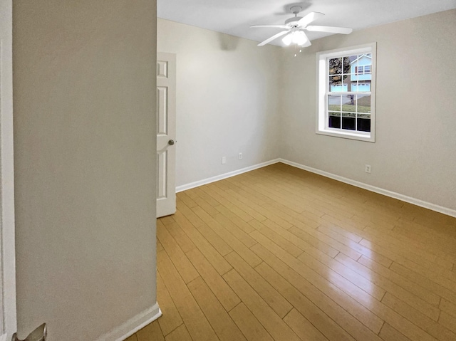 spare room featuring ceiling fan and light wood-type flooring