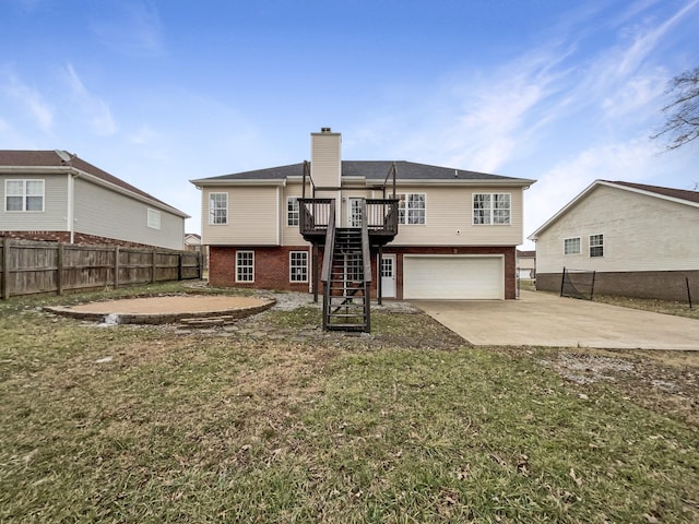 back of house featuring a yard, a garage, and a deck