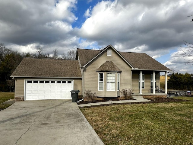 view of front of property with a garage, covered porch, and a front lawn