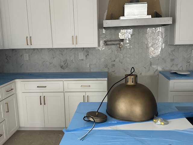 kitchen with white cabinetry and backsplash