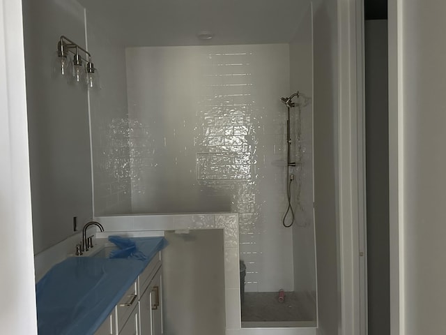 bathroom featuring vanity and a tile shower