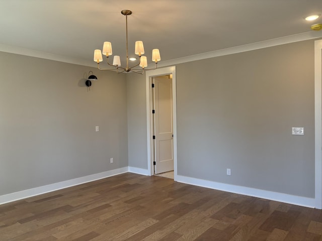 empty room with baseboards, dark wood-style flooring, crown molding, and a chandelier