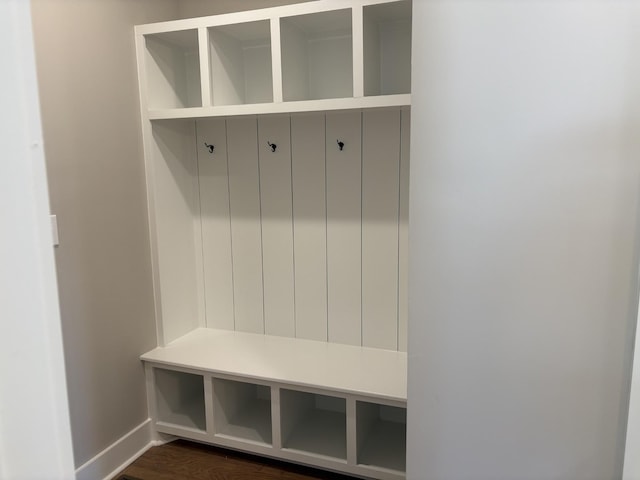 mudroom with dark wood-type flooring and baseboards