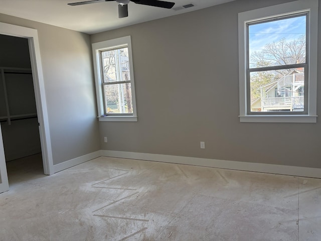 unfurnished bedroom featuring a ceiling fan, visible vents, and baseboards