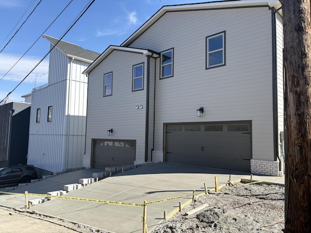 view of home's exterior with a garage and brick siding