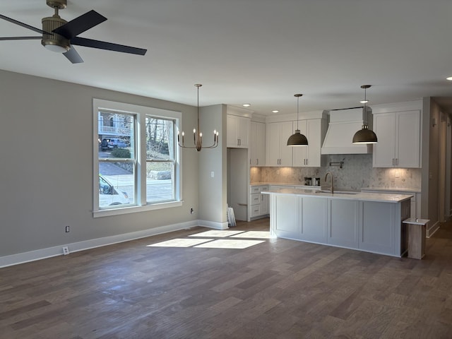 kitchen with premium range hood, white cabinets, light countertops, dark wood-style floors, and tasteful backsplash