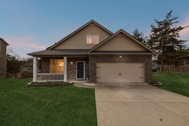 view of front of house with a porch, a garage, and a yard