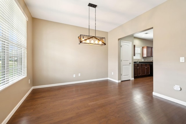 unfurnished room with sink and dark hardwood / wood-style flooring