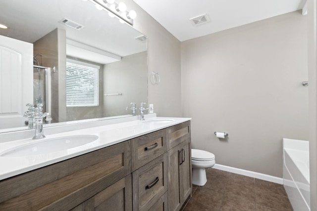 full bathroom featuring vanity, tile patterned floors, shower with separate bathtub, and toilet